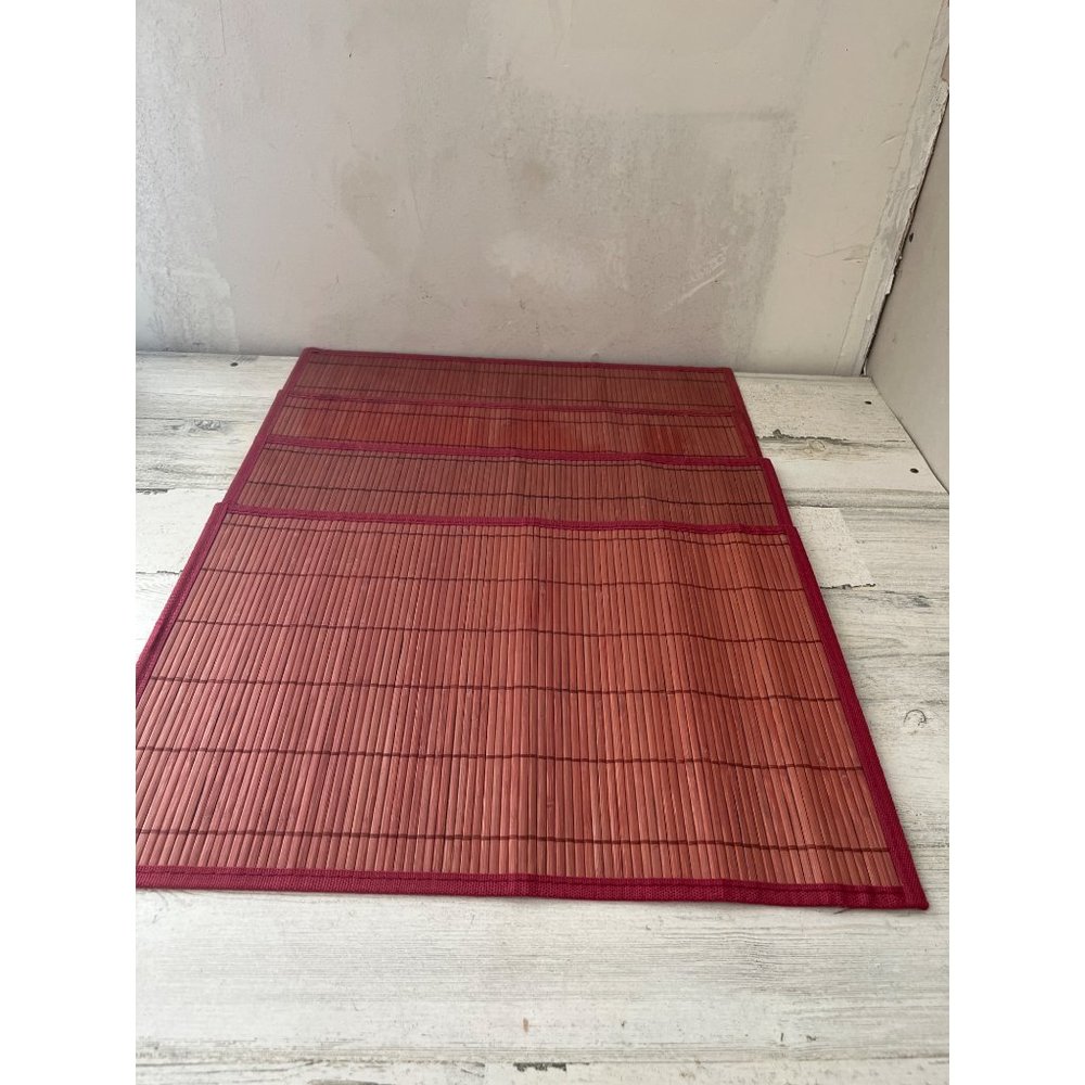 Set of four red rattan bamboo look placemats